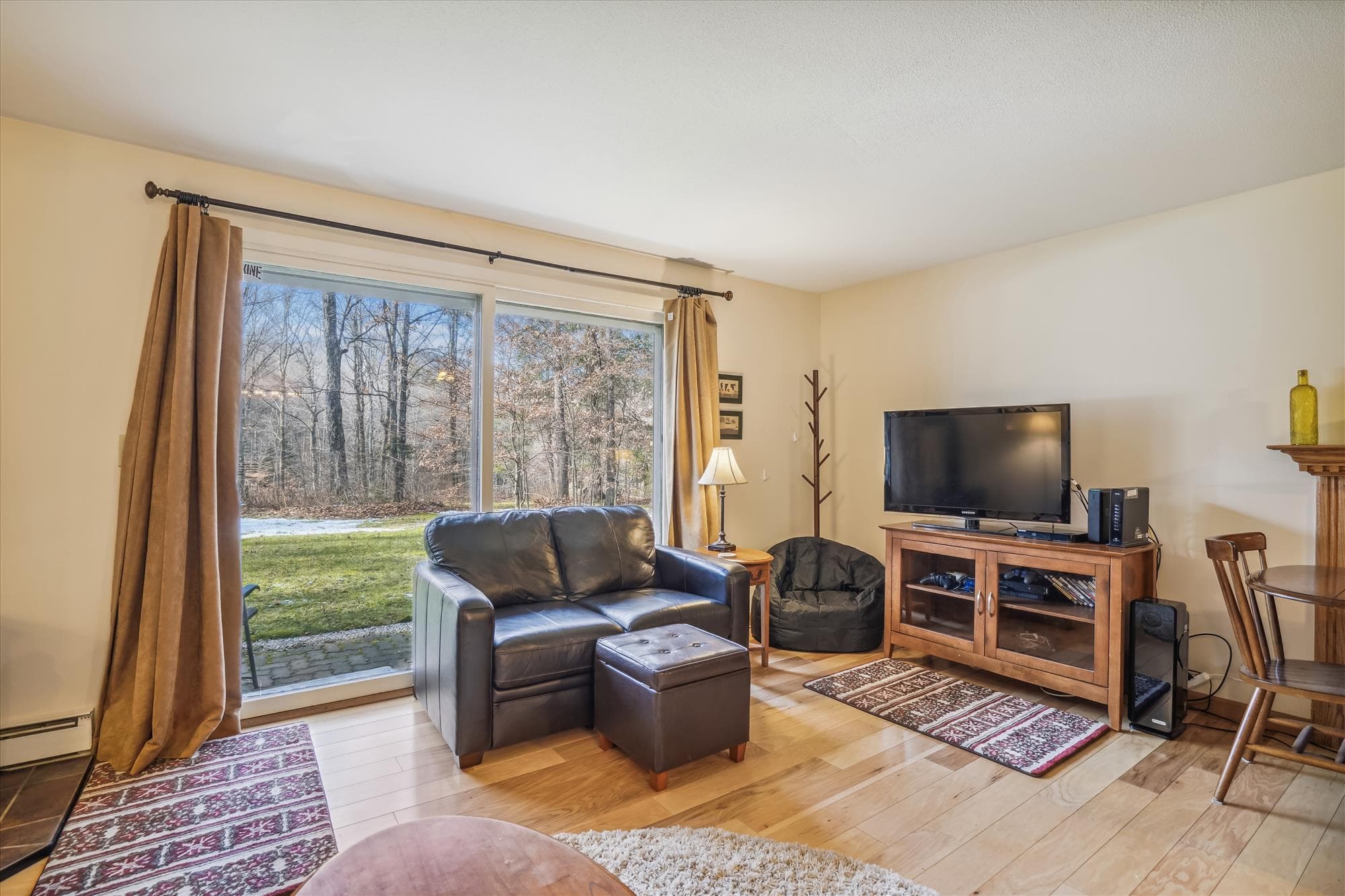 Living room with plenty of seating for your small group. Propane stove to enjoy and warm up after those cold days or just to add some ambiance to your evening. Tons of natural light from your slider door access to back yard and small patio.