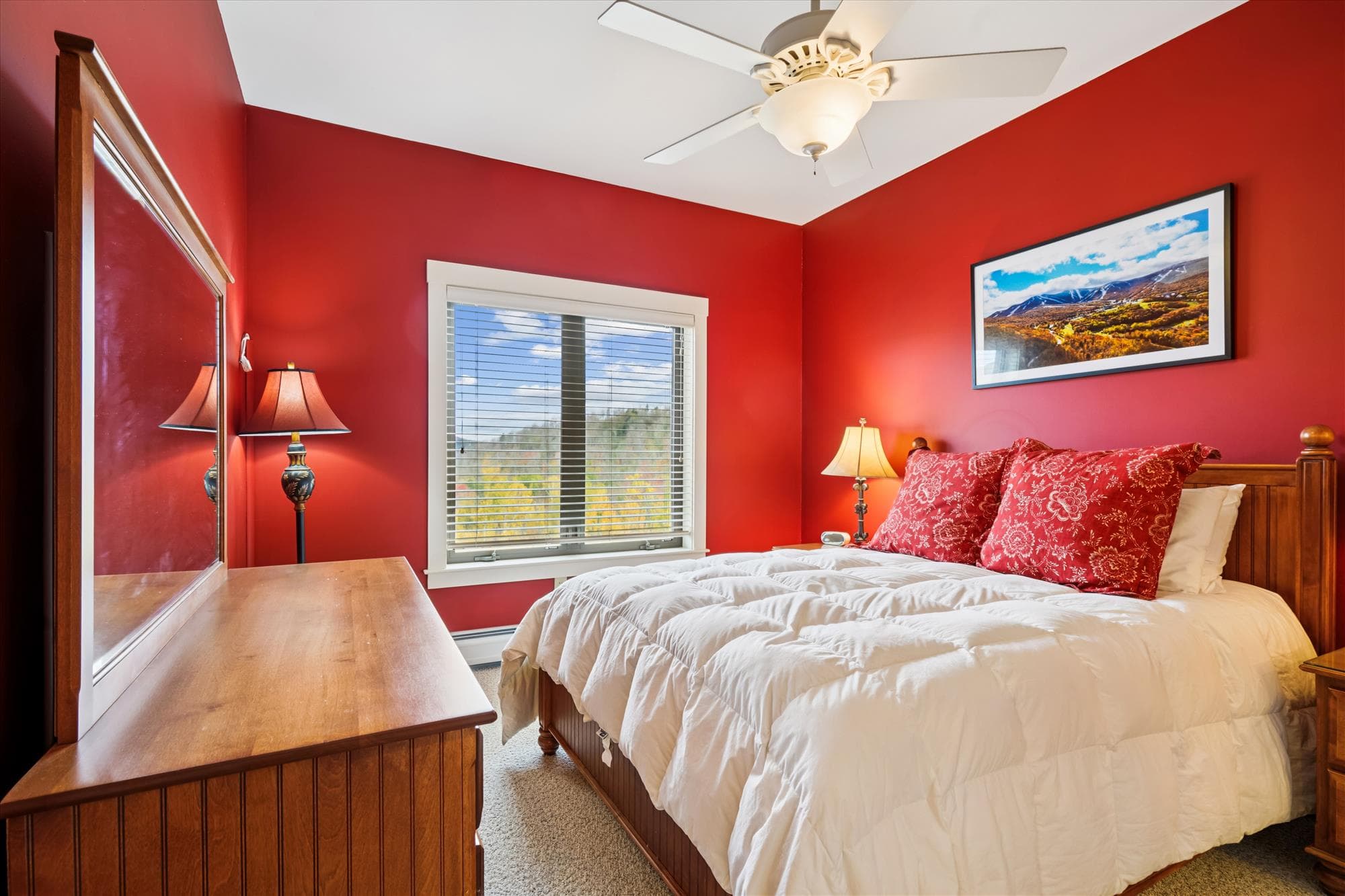 This inviting queen bedroom features warm tones, natural light, and peaceful mountain views. A private ensuite bath adds comfort and convenience for guests looking to unwind after a day exploring Killington.