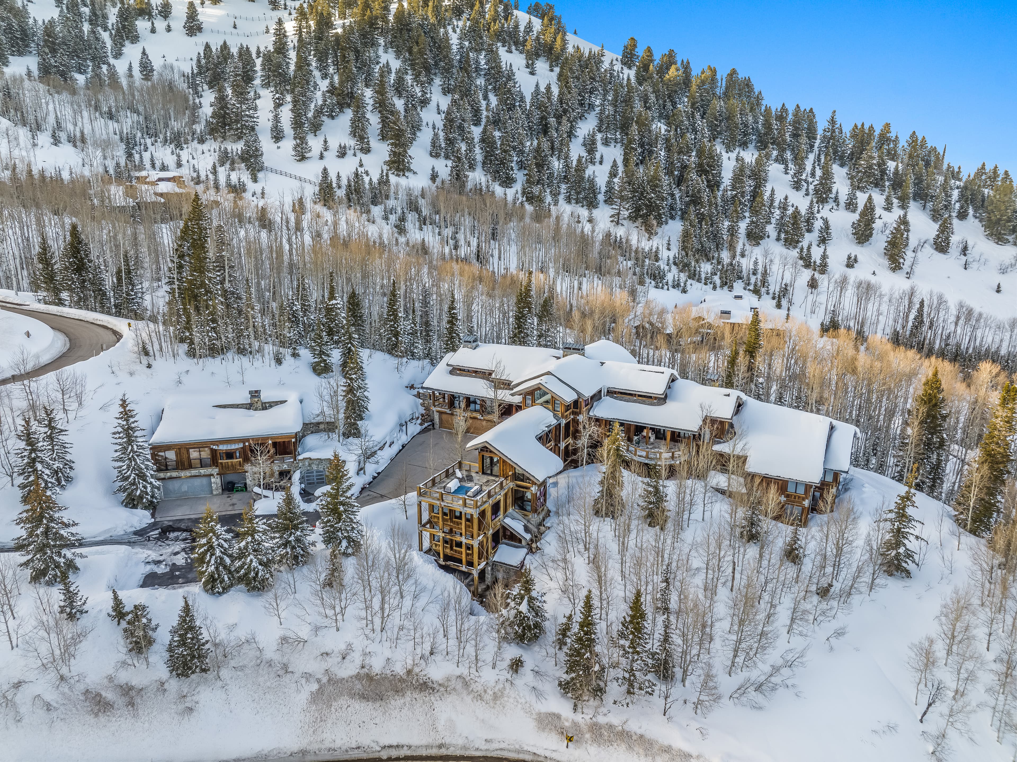 A distant aerial view of this luxury Park City vacation rental, showing off the surrounding forest.