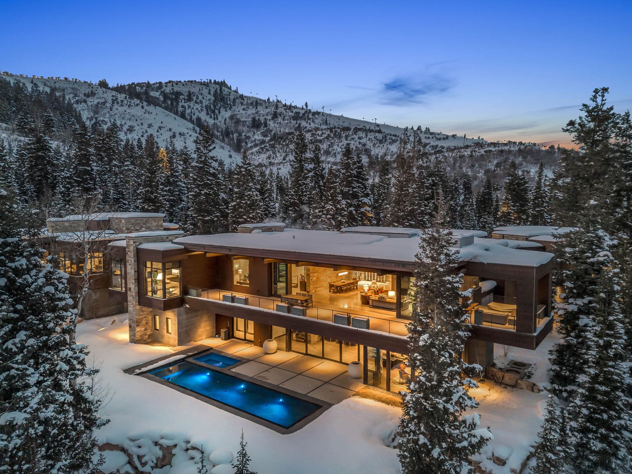 A White Pine Canyon Ranch luxury Park City vacation rental with a pool and snowy mountain views.