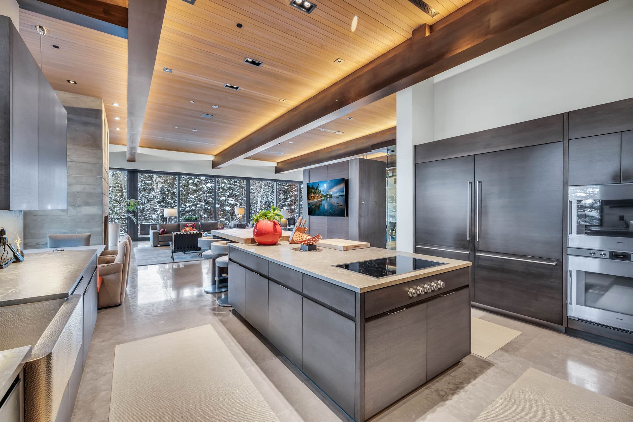 A sleek kitchen with high-end finishes and scenic views.