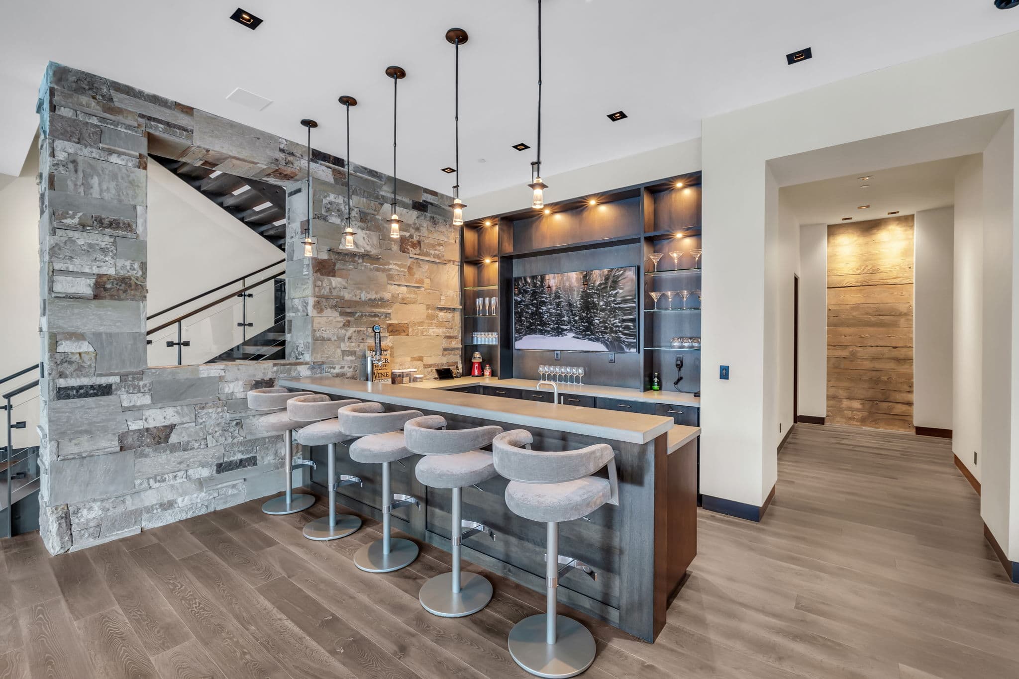 A stylish bar with stone accents and warm lighting.