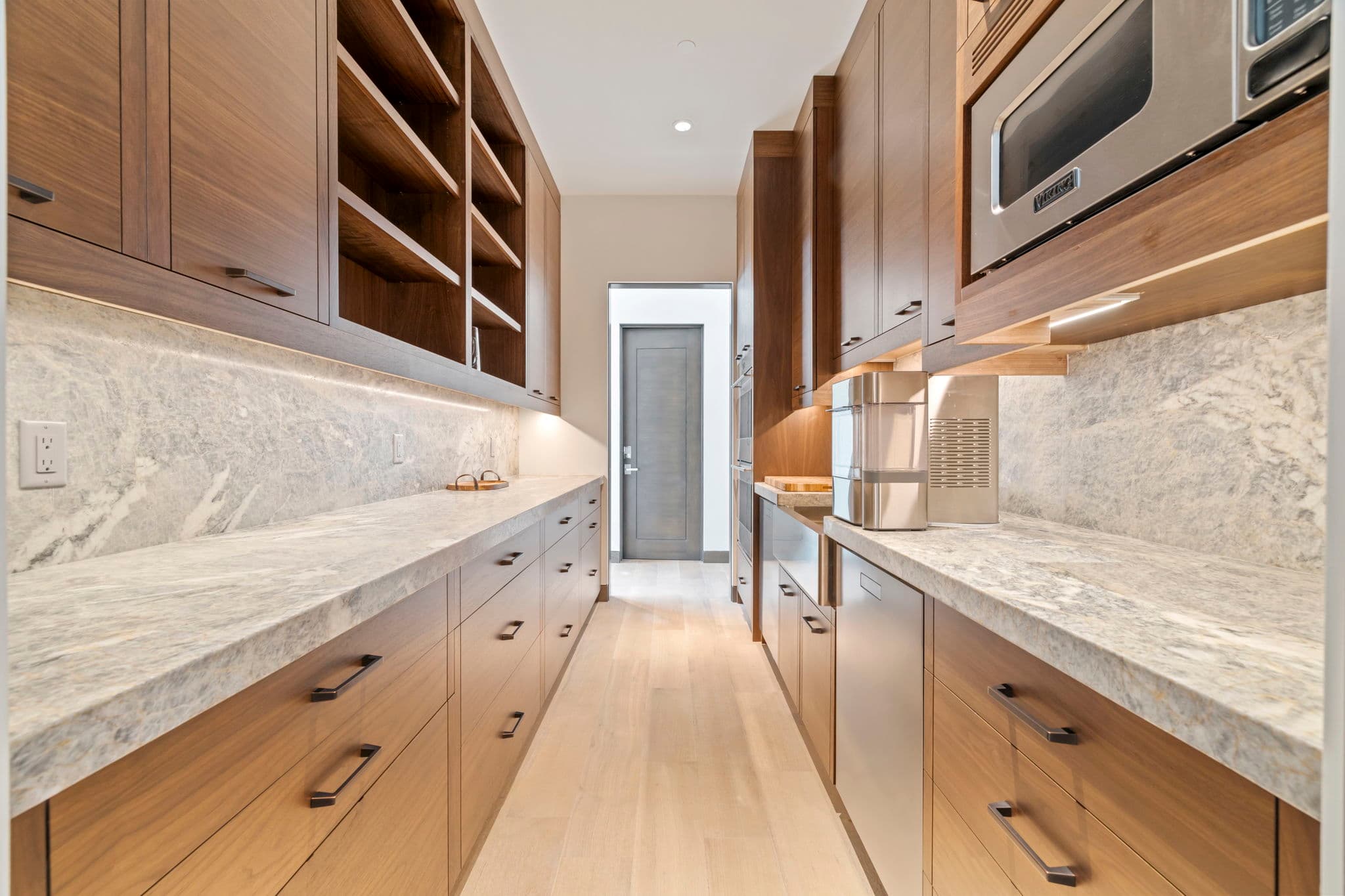 The pantry area with shelving and cabinets.