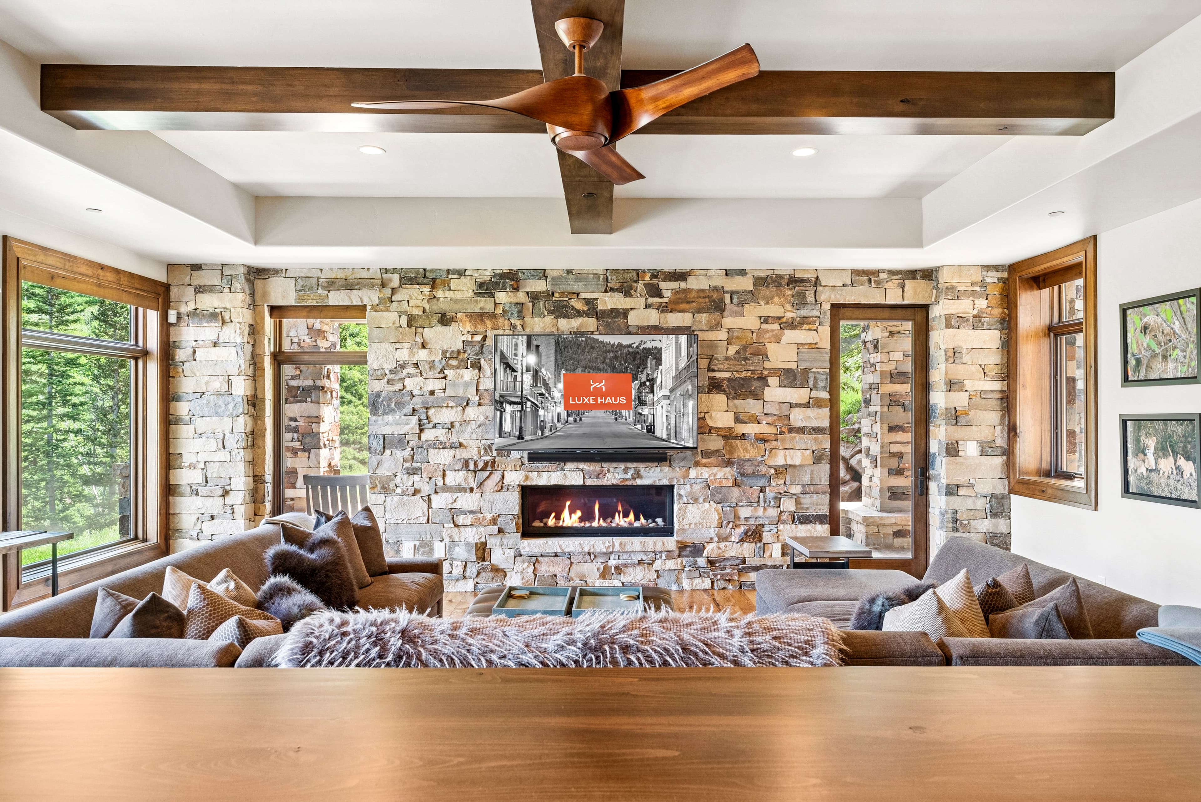 lower level living room with large TV and fireplace
